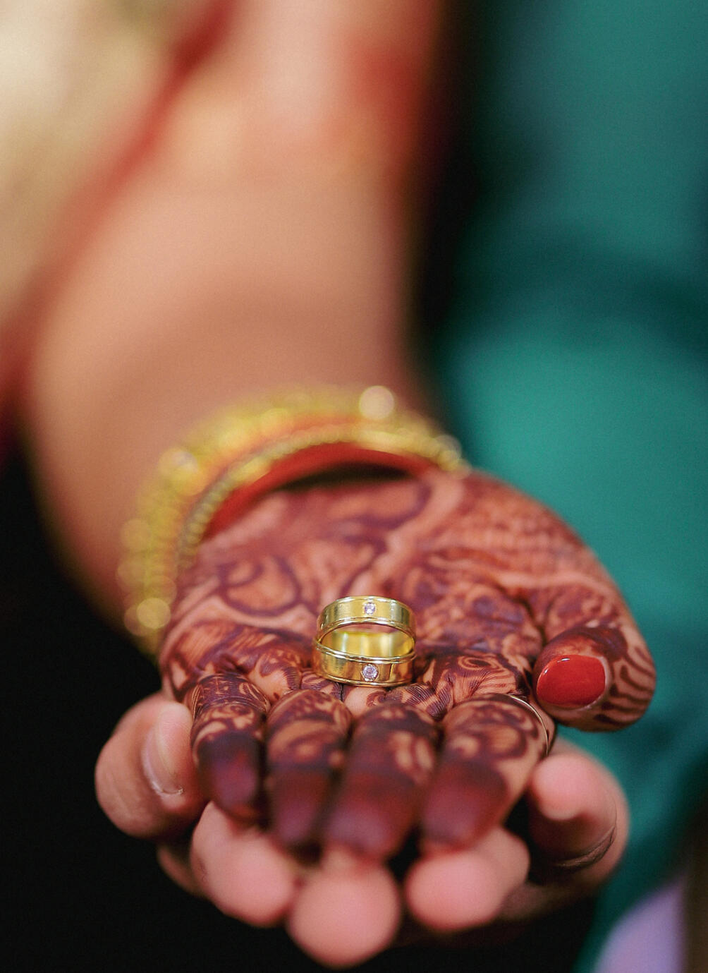 Close-up shot of an engagement ring on a finger, showcasing high-end detail and bokeh photography by Aditya.