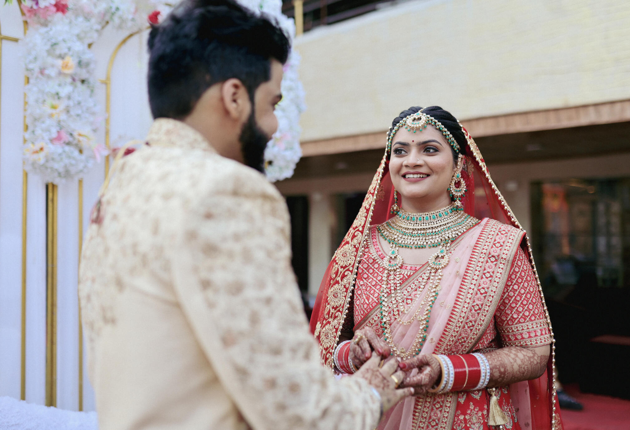 Professional candid couple photography during golden hour in an outdoor landscape, captured by Mumbai-based photographer Aditya.